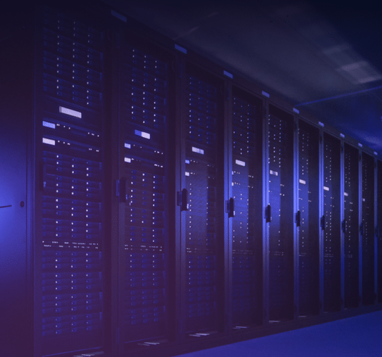 A row of server racks with illuminated indicator lights in a dimly lit data center, highlighting the importance of robust cybersecurity for enterprise security.