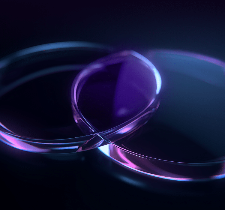 Two transparent, overlapping glass rings with purple and blue light reflections evoke a sense of advanced cybersecurity, placed on a dark surface.