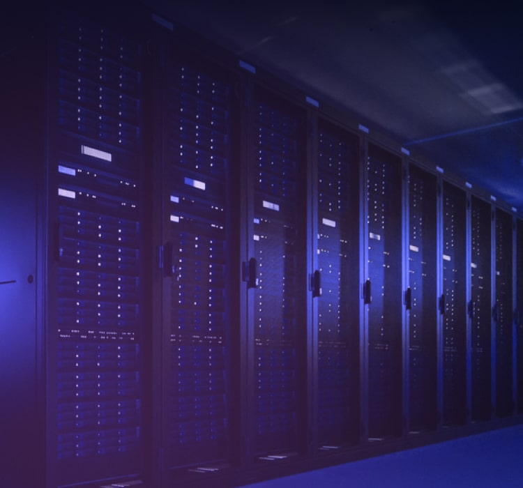 Rows of server racks with blue lighting in a data center, supporting advanced cybersecurity and threat intelligence operations.